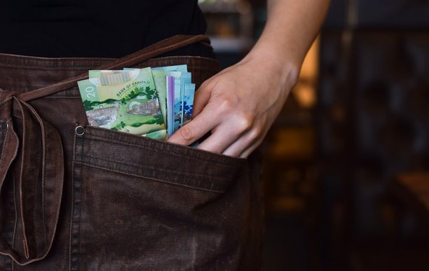 waitress-holding-canadian-money